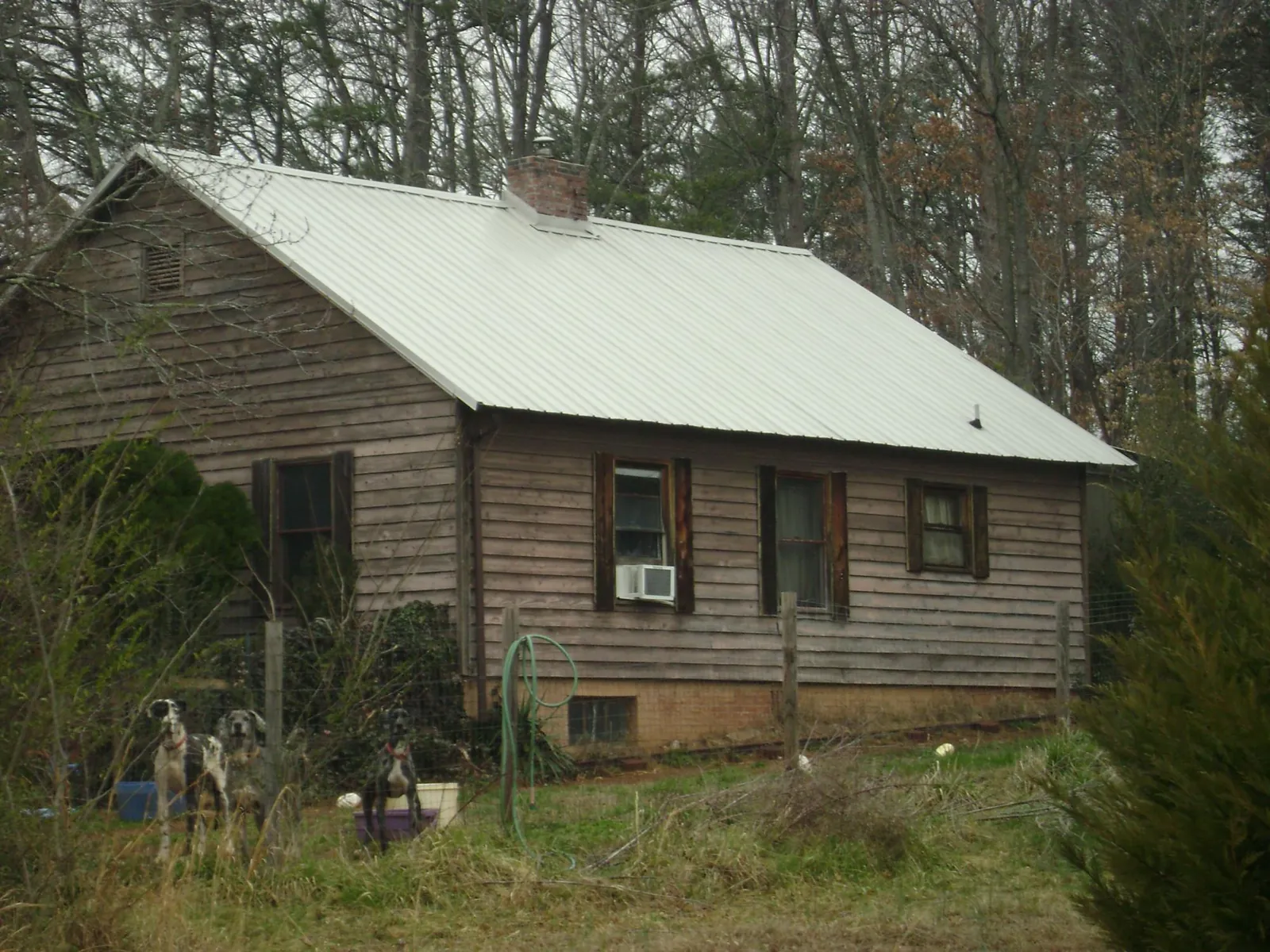 White metal roof on an old wood sided farmhouse, from a Metal Roof Installation job in New Vienna